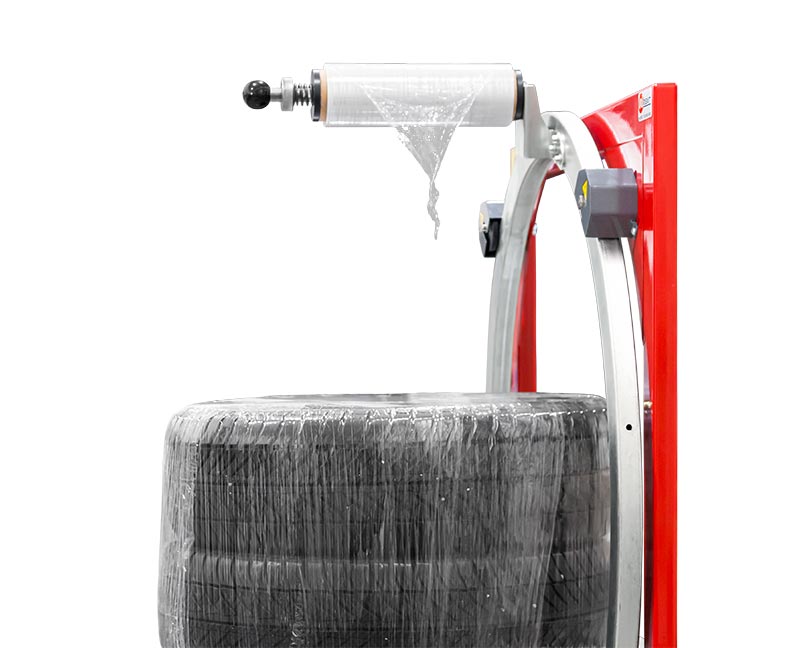 Balicí stroj pro motorizované balení pneumatik a kulatých zásilek